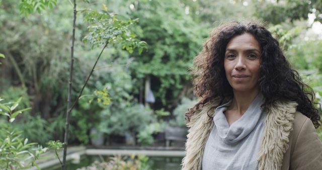 Serene Woman with Curly Hair Posing Outdoors in Nature - Download Free Stock Images Pikwizard.com