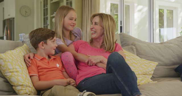 Smiling Mother Spending Quality Time with Her Children on Couch - Download Free Stock Images Pikwizard.com