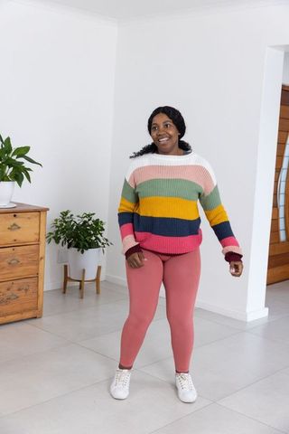 Woman in Colorful Sweater and Leggings Inspired by Casual Modern Living
