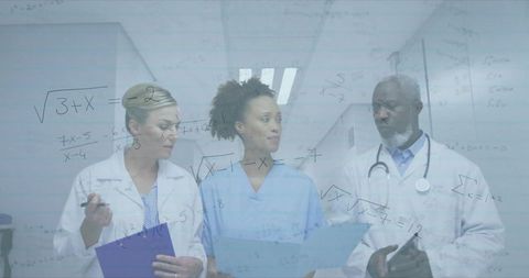 Medical team collaborating over transparent whiteboard with formulas in hospital corridor