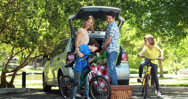 Family unloading camping gear from car in forest park - Download Free Stock Images Pikwizard.com