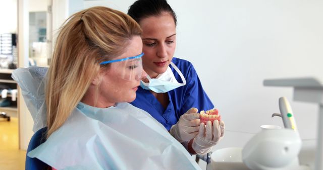 Dentist Explaining Dental Procedure to Female Patient in Office - Download Free Stock Images Pikwizard.com