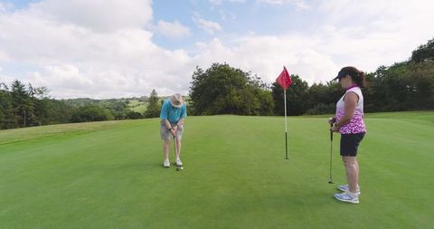 Senior Couple Enjoying Golf on a Scenic Green