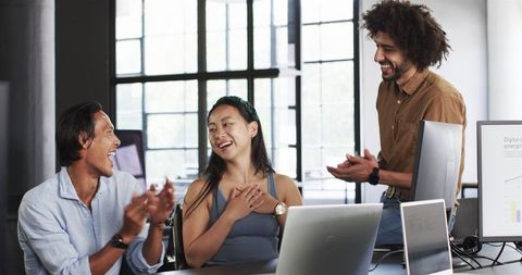 Diverse Team Celebrating Success in Modern Office Setting