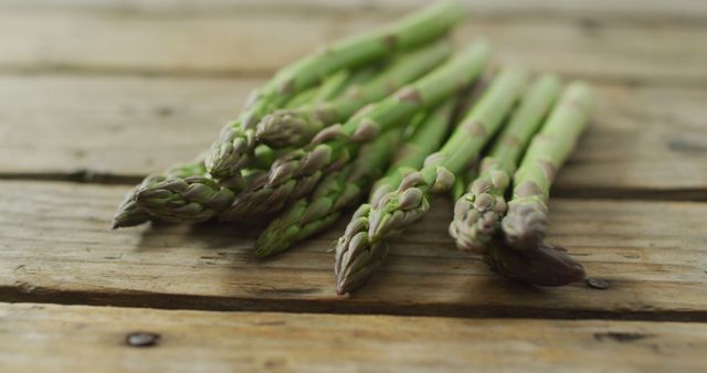 Image of fresh asparagus stalks on wooden background. fusion food, fresh vegetables and healthy eating concept.