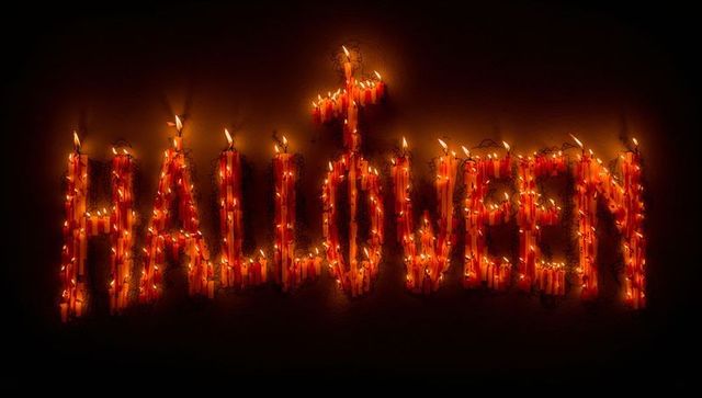 Candle lit halloween word with flickering flame effect