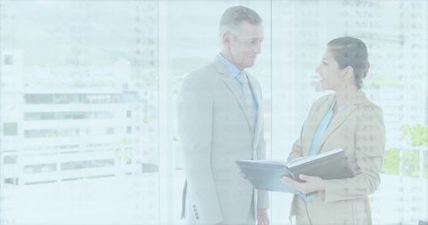 Professional Man and Woman Discussing Office Documents