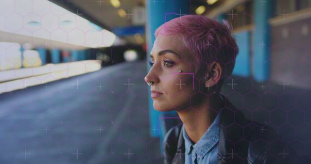 Young woman with distinct pink hair and piercings standing in an urban outdoor environment. Suitable for concepts related to individuality, alternative fashion, urban lifestyle, and personal contemplation.