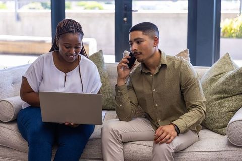 Diverse coworkers collaborating in office lounge