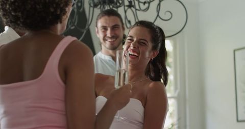 Joyful wedding guests celebrating with champagne