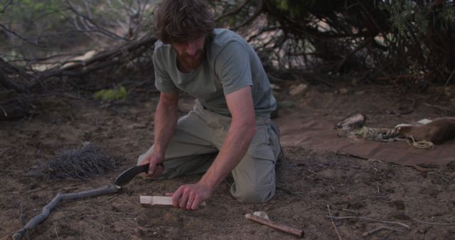 Man Using Survival Skills in Woods with Knife and Firestarter - Download Free Stock Images Pikwizard.com