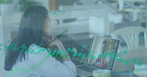Businesswoman in Virtual Meeting with Overlaid Financial Data Graphics