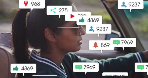 Driving Woman Surrounded by Social Media Notification Icons