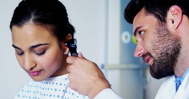 Doctor Using Otoscope to Examine Female Patient's Ear in Medical Check-Up - Download Free Stock Images Pikwizard.com