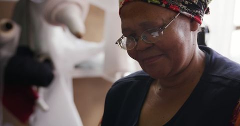 Senior Artisan Creating Hats in Workshop Enjoying Craft
