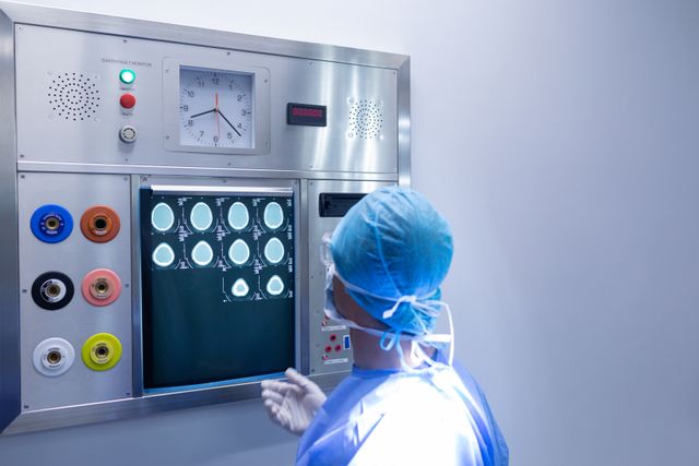 Male surgeon examining x-ray in light box at hospital