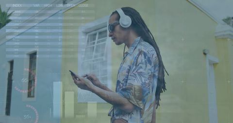 Modern Businessman Analyzing Data on Smartphone with Headphones