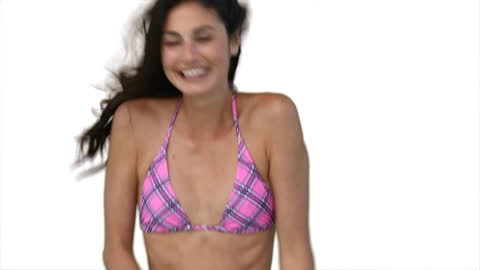 Joyful Woman in Pink Bikini Jumping on White Background