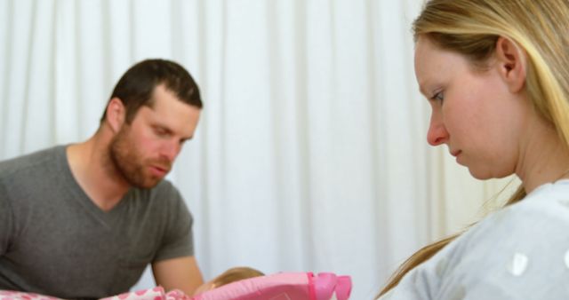 Young Parents Caring for Newborn Baby Together Indoors - Download Free Stock Images Pikwizard.com