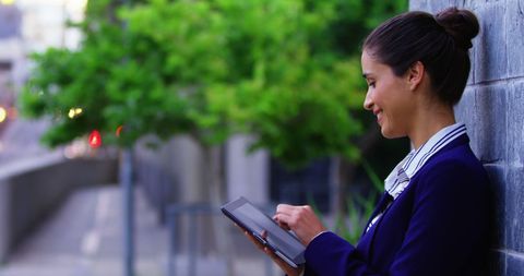 Professional Woman Using Tablet Outdoors with Copy Space