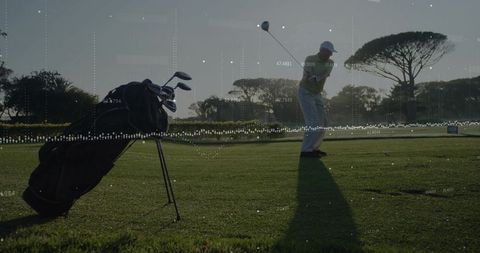 Senior Golfer Swinging with Data Overlay at Scenic Golf Course
