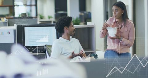 Diverse Colleagues Discuss Financial Data in Modern Office