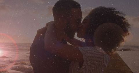 Romantic Couple Kissing on Ocean Pier at Sunset with Starry Overlay