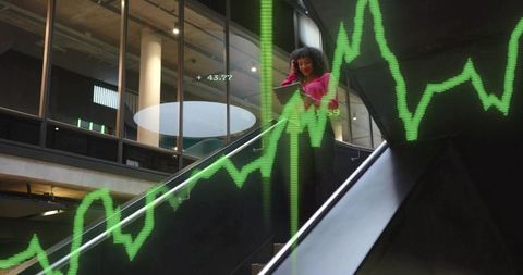 Businesswoman Holding Tablet Walking Down Escalator with Data Overlay