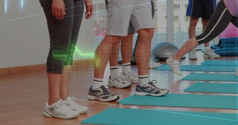 Standing and lunging group fitness legs on mats sneakers footwork training studio