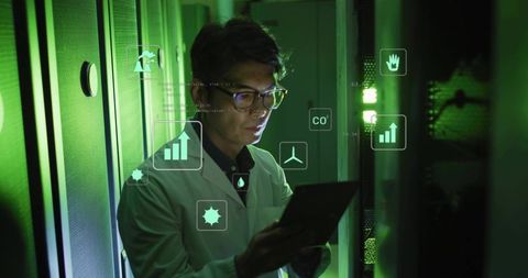 IT Engineer Monitoring Green Data Center Telemetry on Tablet with Holographic Analytics