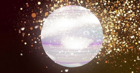 Glowing sphere with golden particle burst in futuristic design