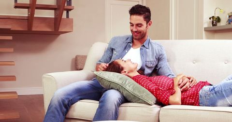 Relaxed Couple Sharing Cozy Moment on Living Room Sofa