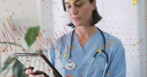 Clinician analyzing digital data on tablet in medical office