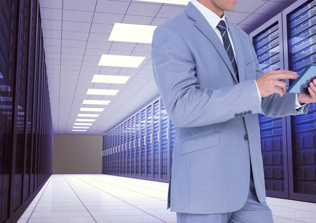 Businessman in a suit using a digital tablet in a modern server room. Ideal for illustrating concepts related to technology, data management, IT professionals, corporate environments, cloud computing, and modern business operations.
