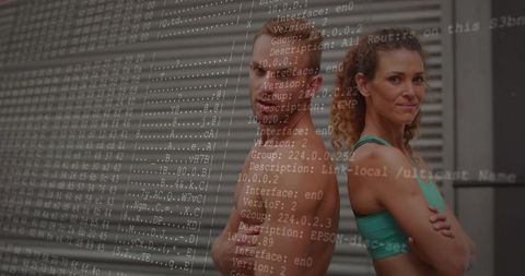 Fitness partners posing back-to-back showing strength with code overlay in urban gym studio