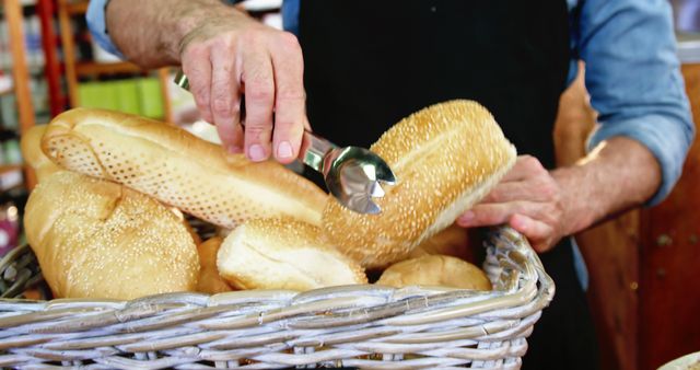 Baker Selecting Fresh Bread from Basket with Tongs - Download Free Stock Images Pikwizard.com
