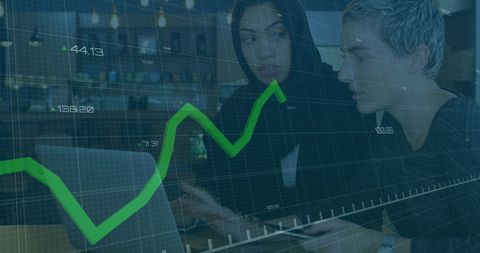 Women collaborating on financial analysis with stock market overlay
