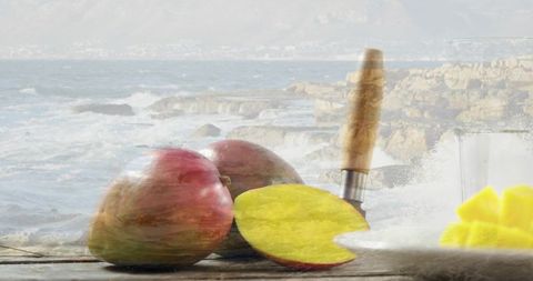 Fresh Mangoes and Knife on Coastal Wooden Table