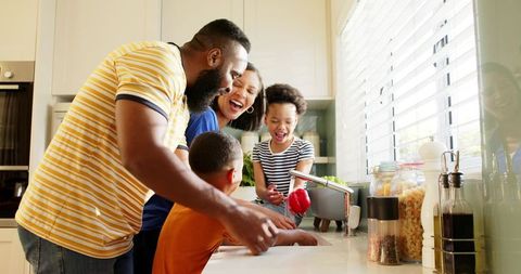Caring Family Preparing Vegetables Together in Modern Kitchen