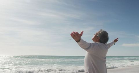 Senior Woman Relaxing on Beach with Outstretched Arms - Download Free Stock Images Pikwizard.com