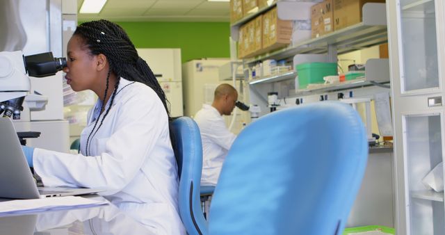 Focused Female Scientist Using Microscope in Modern Laboratory - Download Free Stock Images Pikwizard.com