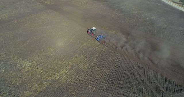 Aerial View of Modern Tractor Plowing Field Creating Large Dust Cloud - Download Free Stock Images Pikwizard.com
