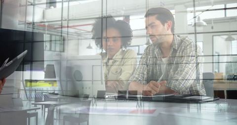 Modern Office Team Reflected in Glass Analyzing Data on Laptop
