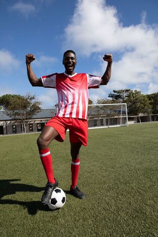 Athletic Man Celebrating Victory on Soccer Field