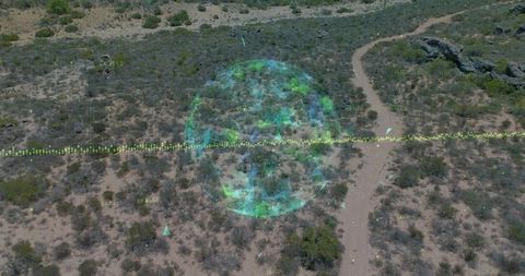 Holographic data sphere overlaying desert trail with waveform markers drone aerial terrain