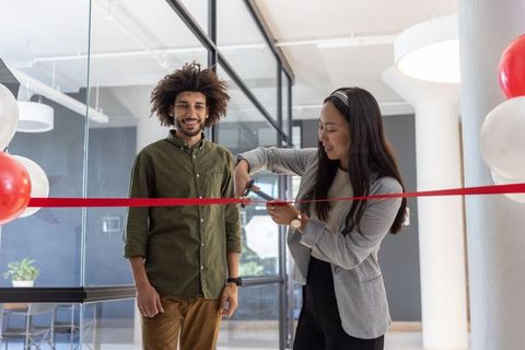 Modern office ribbon cutting ceremony celebrating new venture
