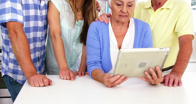 Senior Woman Learning to Use Tablet with Family Support - Download Free Stock Images Pikwizard.com