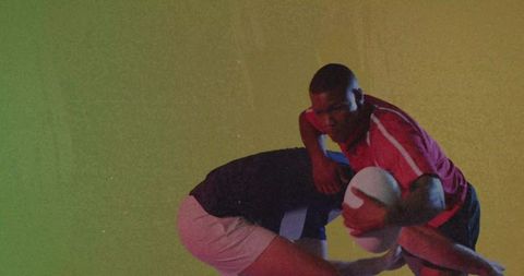 Dynamic Rugby Players in Intense Game Action Against Gradient Background