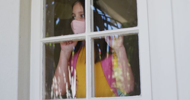 Child Looking Out Home Window Wearing Mask for Safety - Download Free Stock Images Pikwizard.com