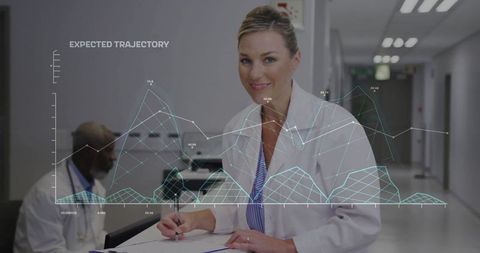 Writing female doctor with medical data overlays in hospital corridor